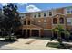 Tan three-story townhome with two-car garage, and landscaping at 8807 White Sage Loop # 1903, Lakewood Ranch, FL 34202