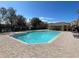Community pool with brick pavers and surrounding lounge chairs at 8807 White Sage Loop # 1903, Lakewood Ranch, FL 34202