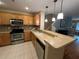 Modern kitchen with stainless steel appliances and light wood cabinets at 8807 White Sage Loop # 1903, Lakewood Ranch, FL 34202