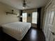 Spacious bedroom with king-size bed and dark hardwood floors at 8807 White Sage Loop # 1903, Lakewood Ranch, FL 34202