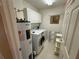 Laundry room with washer, dryer, cabinets, and shelving at 8807 White Sage Loop # 1903, Lakewood Ranch, FL 34202