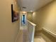 Upper level hallway with carpeted floor and artwork at 8807 White Sage Loop # 1903, Lakewood Ranch, FL 34202
