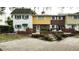 Three attached townhouses with brick fronts and landscaping at 705 W Venice Ave # 705-B, Venice, FL 34285