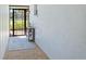 Quaint entryway with a rug, small table and french doors at 3721 Somerville Dr # 1513, Sarasota, FL 34232