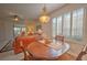 Bright dining area with wood table and chairs, overlooking the living room at 8146 Stirling Falls Cir, Sarasota, FL 34243