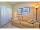 Cozy guest room features a comfortable sofa and ample closet space at 8146 Stirling Falls Cir, Sarasota, FL 34243