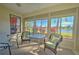 Enclosed patio overlooking a lake with wicker furniture at 8146 Stirling Falls Cir, Sarasota, FL 34243