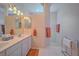 Bathroom with double vanity, walk-in shower, and tiled floors at 8146 Stirling Falls Cir, Sarasota, FL 34243