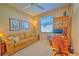 Home office with a tan couch, desk, and built in shelves at 8146 Stirling Falls Cir, Sarasota, FL 34243