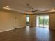 Spacious living room with tile floors, sliding glass doors, and ceiling fan at 2275 Hamburg Ln, Punta Gorda, FL 33983