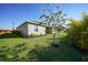 Landscaped backyard with lush lawn and flowering tree at 2275 Hamburg Ln, Punta Gorda, FL 33983