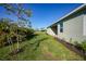 Landscaped backyard with lush greenery and a spacious lawn at 2275 Hamburg Ln, Punta Gorda, FL 33983