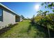 Spacious backyard with green lawn and tropical plants at 2275 Hamburg Ln, Punta Gorda, FL 33983