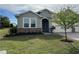 Landscaped front yard with a neutral-colored exterior at 2275 Hamburg Ln, Punta Gorda, FL 33983