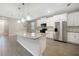 Kitchen island with granite countertop and modern pendant lighting at 2275 Hamburg Ln, Punta Gorda, FL 33983