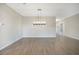 Spacious dining room with wood-look tile floors and a chandelier at 2275 Hamburg Ln, Punta Gorda, FL 33983