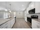 Modern kitchen with white cabinets, granite countertops and stainless steel appliances at 2275 Hamburg Ln, Punta Gorda, FL 33983