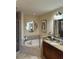 Elegant bathroom features a soaking tub, granite counters, and a separate glass-enclosed shower at 7612 Lake Vista Ct # 305, Lakewood Ranch, FL 34202