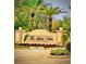 Elegant community sign surrounded by lush landscaping and palm trees at 7612 Lake Vista Ct # 305, Lakewood Ranch, FL 34202