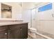 Elegant bathroom with dark wood vanity, a walk-in shower, and updated fixtures at 20910 Parkstone Ter, Bradenton, FL 34202