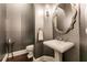 Elegant powder room with patterned wallpaper and ornate mirror at 20910 Parkstone Ter, Bradenton, FL 34202