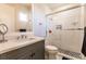 Modern bathroom with gray vanity, white tile shower, and large mirror at 20910 Parkstone Ter, Bradenton, FL 34202