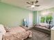 Bedroom with light walls, a gray sofa, and a large window at 20910 Parkstone Ter, Bradenton, FL 34202