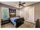 Cozy bedroom with a double bed, a ceiling fan, and plenty of natural light at 20910 Parkstone Ter, Bradenton, FL 34202