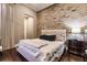 Spacious bedroom with a brick accent wall and hardwood floors at 20910 Parkstone Ter, Bradenton, FL 34202