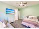 Bedroom with light walls, a gray sofa and a large TV at 20910 Parkstone Ter, Bradenton, FL 34202