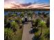 Luxury waterfront home with circular driveway and palm trees at 20910 Parkstone Ter, Bradenton, FL 34202