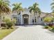Two-story home with a paver driveway and lush landscaping at 20910 Parkstone Ter, Bradenton, FL 34202