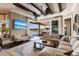 Bright living room boasts a sectional sofa, large windows, and views of the pool area at 20910 Parkstone Ter, Bradenton, FL 34202