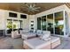 Relaxing outdoor patio area with sectional seating and ceiling fan at 20910 Parkstone Ter, Bradenton, FL 34202