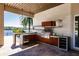 Luxury outdoor kitchen with stainless steel appliances and concrete countertop at 20910 Parkstone Ter, Bradenton, FL 34202