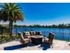 Fire pit and seating area overlooking lake at 20910 Parkstone Ter, Bradenton, FL 34202