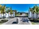 Grand gated entrance with lush landscaping and swaying palm trees in an upscale neighborhood at 7909 20Th W Pl, Bradenton, FL 34209