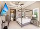 Main bedroom with a large four poster bed and TV at 20910 Parkstone Ter, Bradenton, FL 34202