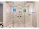 Spacious walk-in shower with marble tile, glass enclosure, and dual shower heads at 20910 Parkstone Ter, Bradenton, FL 34202