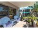 Private balcony with patio furniture and lush greenery at 1400 Barcarrota Blvd W # 201, Bradenton, FL 34205