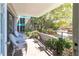 Private balcony with patio furniture and lush greenery at 1400 Barcarrota Blvd W # 201, Bradenton, FL 34205