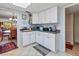 Condo kitchen with white cabinets and corner counter with appliances at 1400 Barcarrota Blvd W # 201, Bradenton, FL 34205