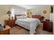 Spacious main bedroom with a king-size bed and wood dresser at 1400 Barcarrota Blvd W # 201, Bradenton, FL 34205