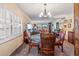 Dining room with round glass table, wooden chairs, and chandelier at 1400 Barcarrota Blvd W # 201, Bradenton, FL 34205