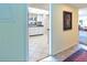 View into kitchen with white cabinets and tile floor from entryway at 1400 Barcarrota Blvd W # 201, Bradenton, FL 34205