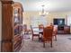 Dining area with round glass table, wooden chairs, and china cabinet at 1400 Barcarrota Blvd W # 201, Bradenton, FL 34205