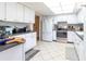 Condo kitchen with white cabinets, stainless steel appliances and tile floor at 1400 Barcarrota Blvd W # 201, Bradenton, FL 34205