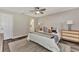 Inviting bedroom showcasing a large king-size bed, ceiling fan, and two dressers, with a glimpse of the bathroom at 4512 Ulster Ave, North Port, FL 34287
