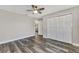 Bright bedroom boasting hardwood floors, a ceiling fan, closet and an open layout with a view of other rooms at 4512 Ulster Ave, North Port, FL 34287