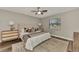 Relaxing bedroom featuring a king bed, ceiling fan, two dressers, and natural light from a large window at 4512 Ulster Ave, North Port, FL 34287